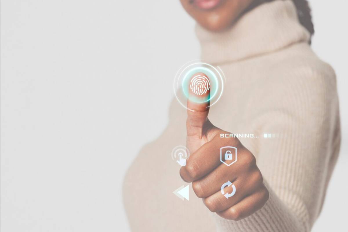 A person in a turtleneck activating a futuristic fingerprint scanning interface with digital icons around their finger.