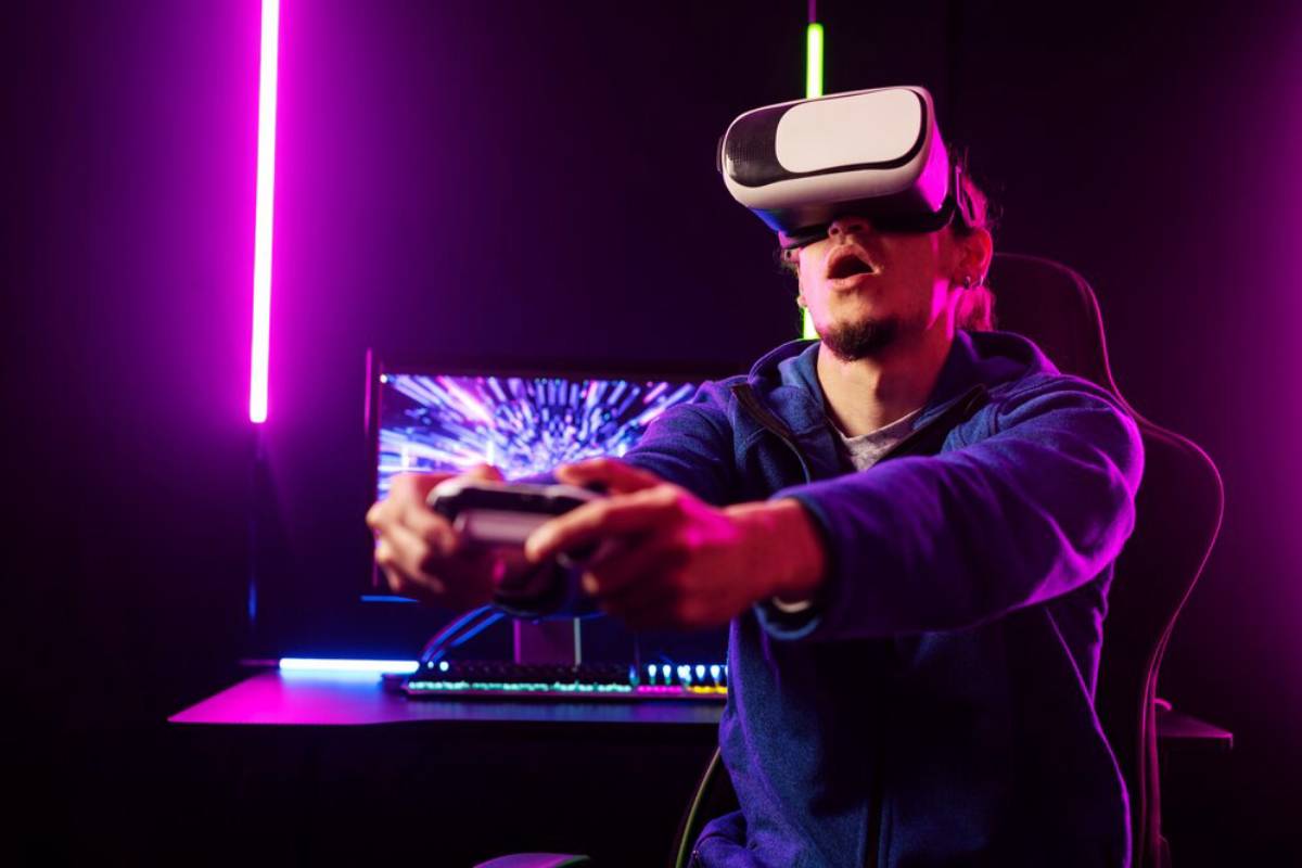 A man wearing a VR headset and holding a game controller, immersed in a virtual reality game with colorful neon lights.